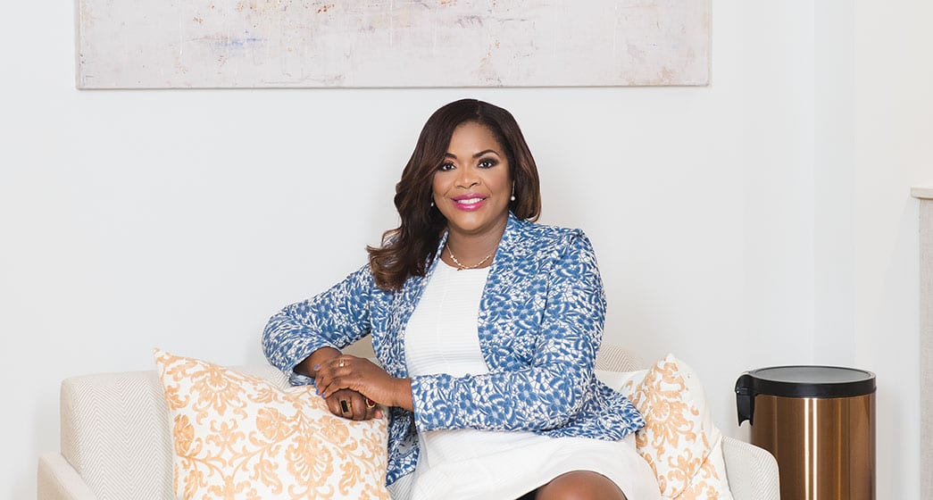 Dr. Cindy Duke sitting on her couch.